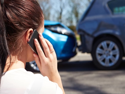 a woman on the phone after a car accident